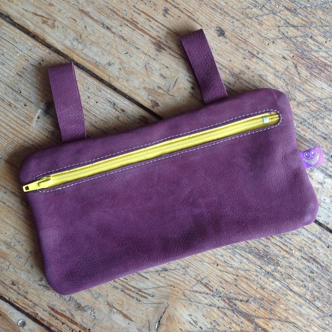 Purple leather etui with yellow zipper